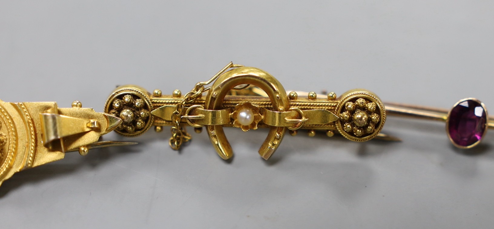 Two early 20th century 9ct and gem set bar brooches, gross weight 4.7 grams, a similar 15ct horseshoe bar brooch, gross 3.4 grams, two other yellow metal and gem set bar brooches, gross 10 grams, a 22ct gold and white op